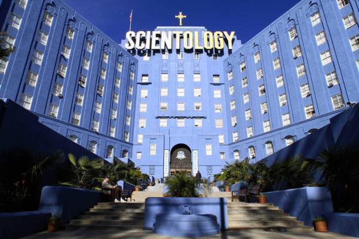 Photo features a blue building with the words “Scientology” on the front. It is the Scientology building that is located in Los Angeles. 